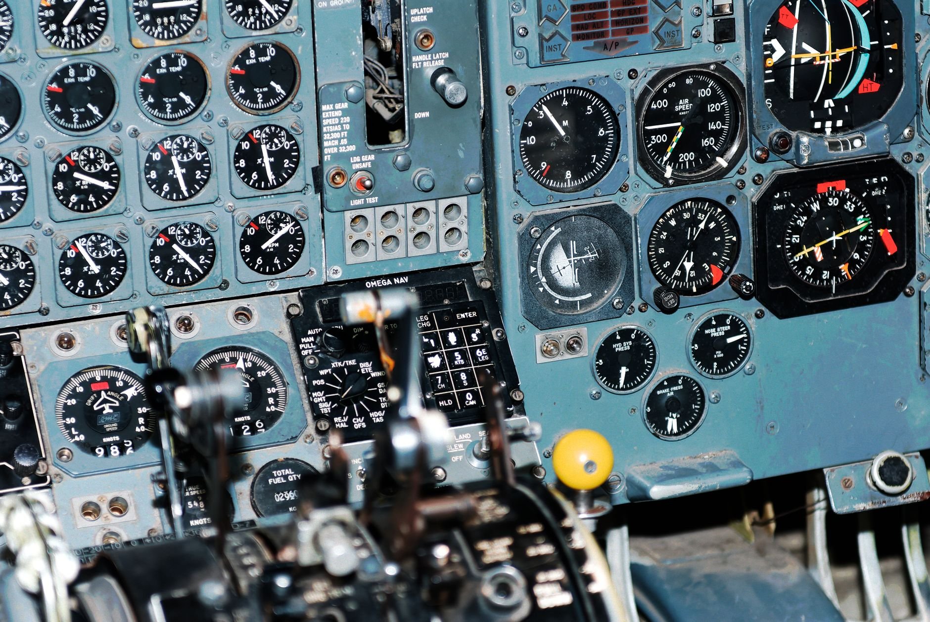 Close-up photo of an aircraft cockpit showcasing various aviation control panels and instruments